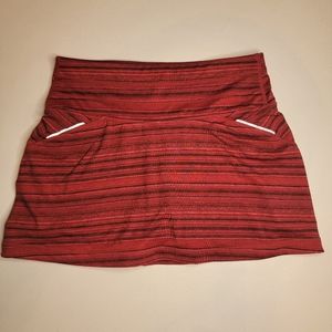 Athleta tennis skirt with attached shorts, red with black stripes, size XS